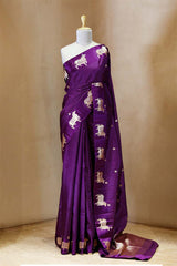 A purple Banarasi silk saree with Pichwai border for Navratri, Diwali, Durga Puja, and weddings, displayed on a mannequin.