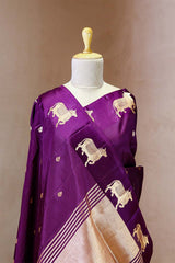 A purple Banarasi silk saree with Pichwai border for Navratri, Diwali, Durga Puja, and weddings, displayed on a mannequin.