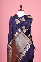 A navy blue Banarasi silk saree with Pichwai border for Navratri, Diwali, Durga Puja, and weddings, displayed on a mannequin.
