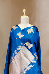A rani blue Banarasi silk saree with gold zari border for Navratri, Diwali, Durga Puja, and weddings, displayed on a mannequin.