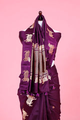 A purple Banarasi silk saree with gold zari border for Navratri, Diwali, Durga Puja, and weddings, displayed on a mannequin.