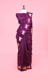 A purple Banarasi silk saree with gold zari border for Navratri, Diwali, Durga Puja, and weddings, displayed on a mannequin.
