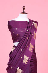 A purple Banarasi silk saree with gold zari border for Navratri, Diwali, Durga Puja, and weddings, displayed on a mannequin.
