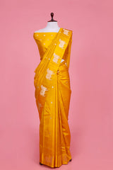 A yellow Banarasi silk saree with Pichwai zari border for Navratri, Diwali, Durga Puja, and weddings, displayed on a mannequin.