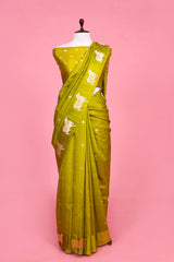 A henna green Banarasi silk saree with zari border for Navratri, Diwali, Durga Puja, and weddings, displayed on a mannequin.