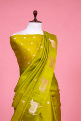 A henna green Banarasi silk saree with zari border for Navratri, Diwali, Durga Puja, and weddings, displayed on a mannequin.