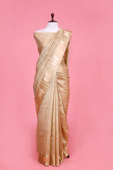 A beige Banarasi silk saree with gold zari border for Navratri, Diwali, Durga Puja, and weddings, displayed on a mannequin.