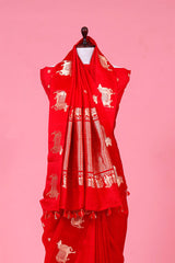 A rani red Banarasi silk saree with gold zari border for Navratri, Diwali, Durga Puja, and weddings, displayed on a mannequin.