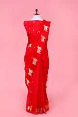 A rani red Banarasi silk saree with gold zari border for Navratri, Diwali, Durga Puja, and weddings, displayed on a mannequin.