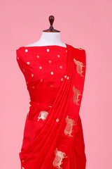 A rani red Banarasi silk saree with gold zari border for Navratri, Diwali, Durga Puja, and weddings, displayed on a mannequin.