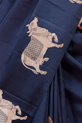 A dark grey Banarasi silk saree with zari border closeup Cow Pichwai art