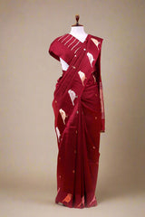 A maroon silk saree draped like Nita Ambani style on a mannequin