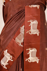 A dark grey Banarasi silk saree with Pichwai border closeup view