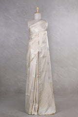 This off white Banarasi Silk Saree with Floral Motifs is a wedding saree and festive wear saree. Free Shipping Available!