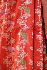 Red fabric with green and pink elephant patterns
