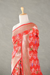 Red Banarasi silk saree with floral patterns on a mannequin against a plain background
