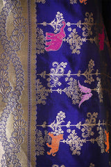 Embroidered fabric with floral patterns and animals on a blue background