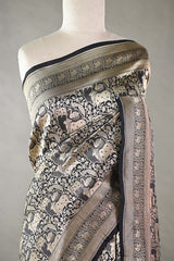 Black Banarasi Silk Saree with Pichwai cow woven pattern, draped on a mannequin against a plain background