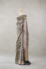 Black Banarasi Silk Saree with Pichwai cow woven pattern, draped on a mannequin against a plain background