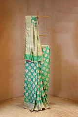 A sea green Banarasi silk saree with zari motifs on dummy