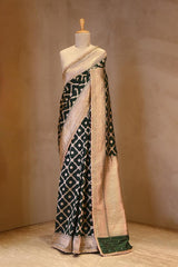 A green Banarasi Silk saree with crisscross pattern on dummy