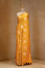 A yellow Banarasi silk saree on dummy