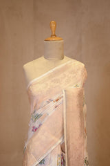 A White banarasi silk saree with multicolor floral work on dummy