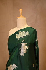 A Green Banarasi Silk Saree with Pichwai Cow woven Border