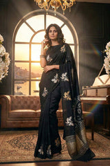 Women Wearing Black Puna Banarasi Silk Saree showing gold and silver zari floral buti and 5 Kadi satin border with bird motifs.