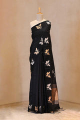 A Dummy Wearing Black Puna Banarasi Silk Saree showing gold and silver zari floral buti and 5 Kadi satin border with bird motifs.