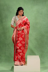 Bride wearing Red Banarasi Katan Silk Saree showing architectural floral gold zari ornaments and handcrafted scalloped lace border.