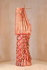 Traditional saree with a pink and orange pattern on a beige background