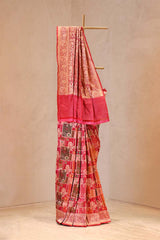 Traditional saree with intricate patterns on a plain background