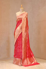 Close up of Red Banarasi Katan Silk Saree showing gold zari woven alfi floral jaal on the body and gold zari woven floral nakshi border.