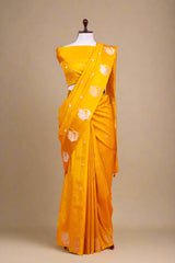 Yellow Banarasi Silk saree draped on a mannequin for the haldi ceremony