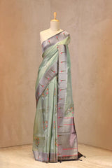 Close up of Pastel Green and Grey Semi-Tissue Saree showing silver zari and meenakari floral buta motifs on the body.