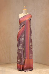 Close up of Rust Mauve Semi Silk Saree showing digital floral prints across the body and plain shaded border with zari stripes on the pallu.