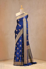 Close up of Royal Blue Semi Satin Silk Saree showing gold zari woven bird motifs with Meenakari detailing and gold zari brocade border.