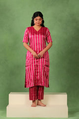 Magenta pink tissue silk kurta pant set with silver zari vertical stripes, V-neck kurta with bead work sleeves, and matching pants