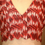 Red, black, and white patterned top on a mannequin