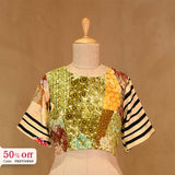 Colorful printed top blouse on a mannequin with a beige background, with promotional text of 50% off