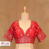 Red blouse with gold patterns on a mannequin against a beige background, with a 25% off label.