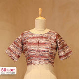 Textured woven top blouse on a mannequin with a beige background, with promotional text of 50% off