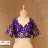 A purple designer silk blouse on mannequin, promoting Diwali sale offer on blouses up to 50%