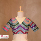 Colorful striped blouse on a mannequin with a beige background