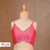 Red patterned top on a mannequin with a brown background and promotional text.