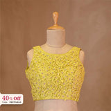Yellow designer blouse on a mannequin with with a promotional text Diwali sale offer on blouses up to 50%