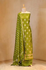 Green saree with floral patterns on a mannequin against a beige background