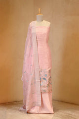 Pink saree with floral patterns on a mannequin against a beige background