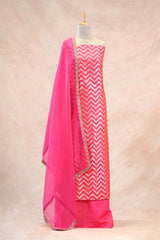Pink and white chevron patterned dress with matching dupatta on a beige background